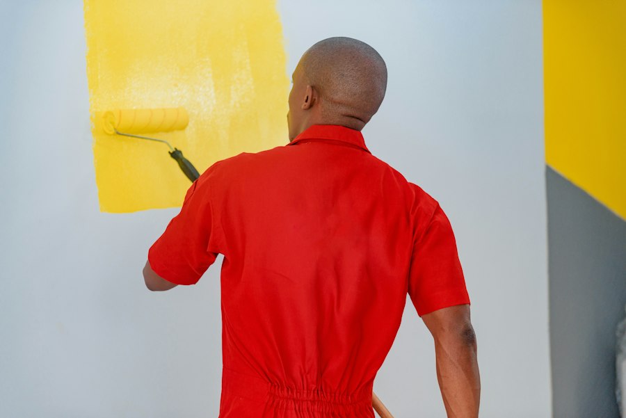 Maler streicht eine Wand gelb